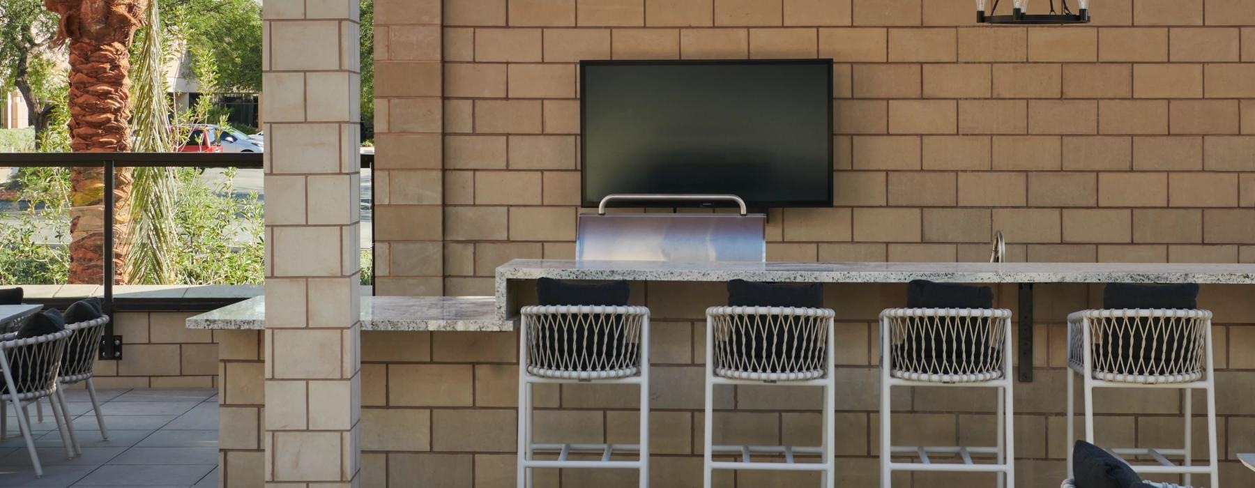 a patio with chairs and a fireplace with Darwin D. Martin House in the background